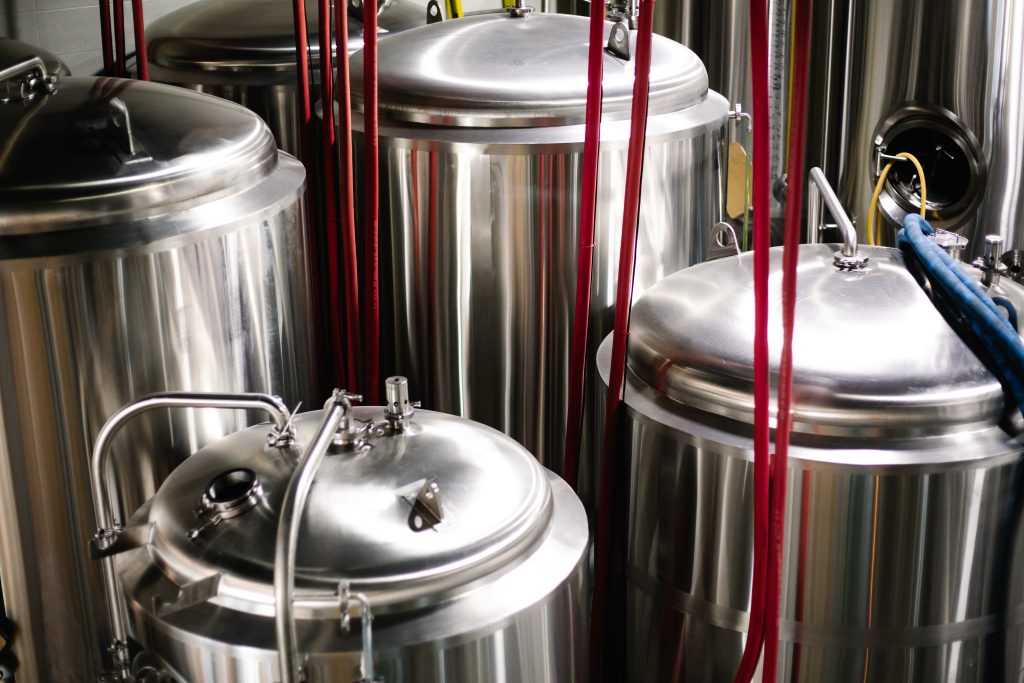 Ale Architect brewhouse tanks behind the taproom glass